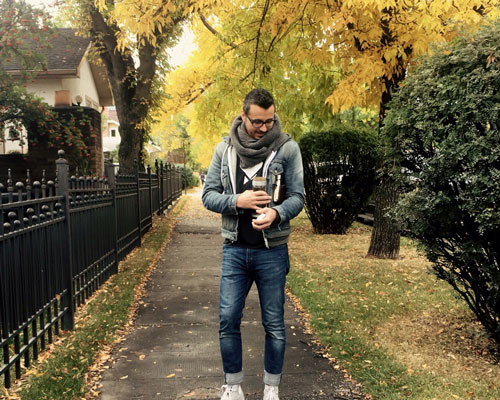 Dario walking on street with coffee