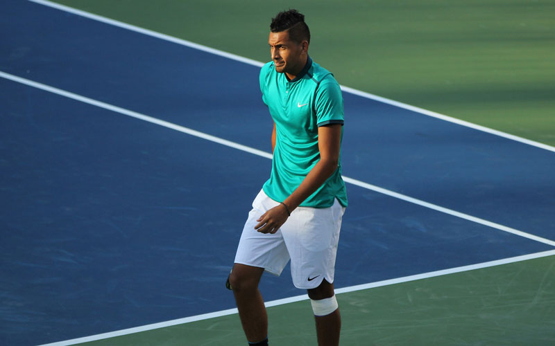 Nick Kyrgios walking across tennis court