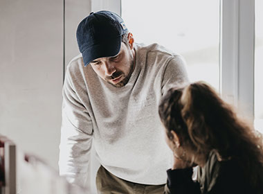 Man leaning over to talk to friend