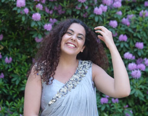 Akanksha poses in front of flowers