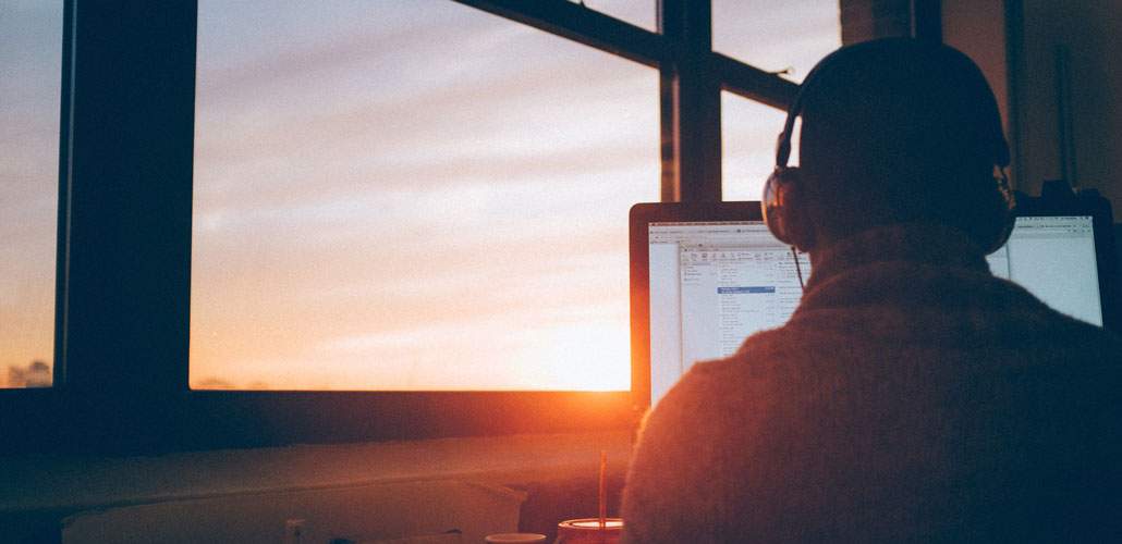 Man with headphones on laptop