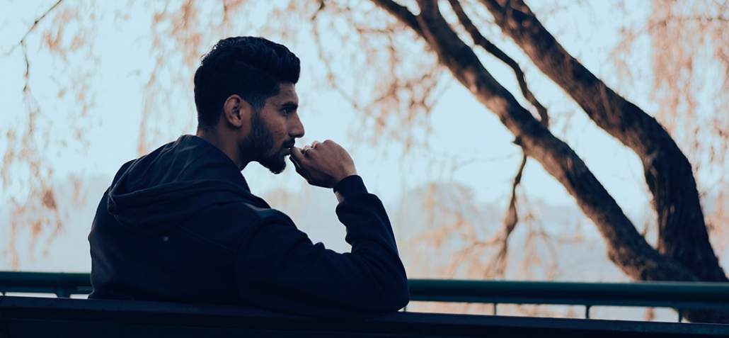 Man sitting on bench, deep in thought